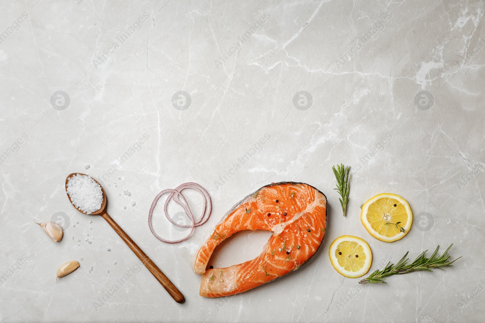 Photo of Fresh raw salmon steak and seasonings on gray background, top view