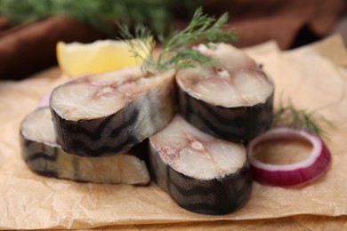 Slices of tasty salted mackerel and onion on table, closeup