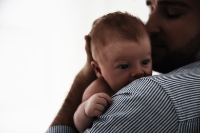 Father with his newborn baby on white background, closeup