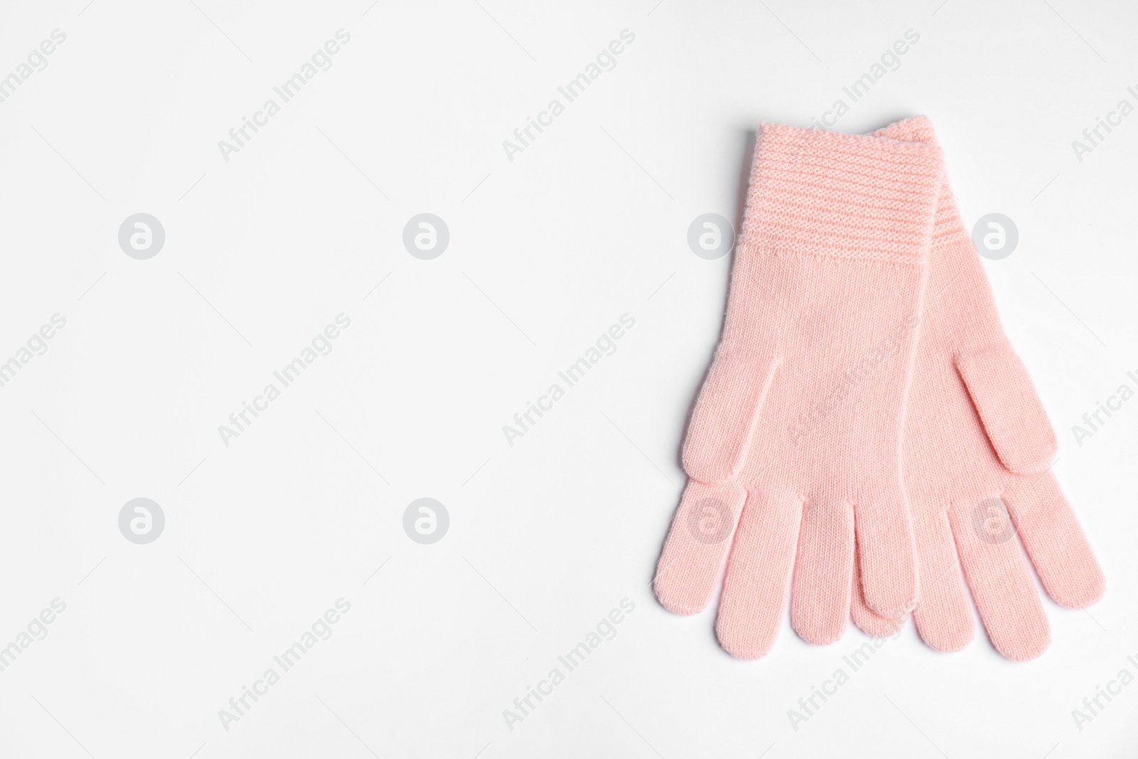 Photo of Stylish pink gloves on white background, top view with space for text. Autumn clothes