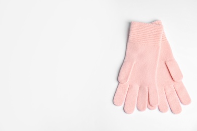 Photo of Stylish pink gloves on white background, top view with space for text. Autumn clothes