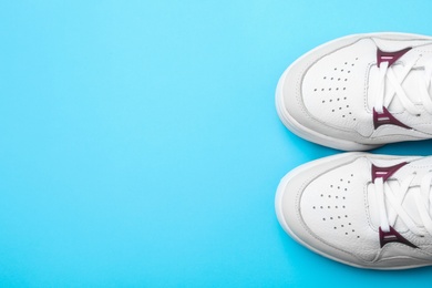 Photo of Pair of stylish shoes on blue background, top view. Space for text