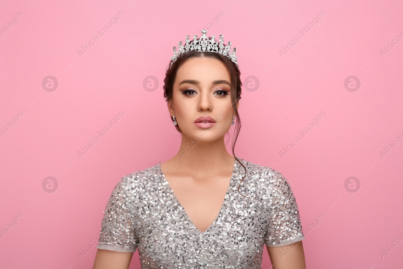 Photo of Beautiful young woman wearing luxurious tiara on pink background