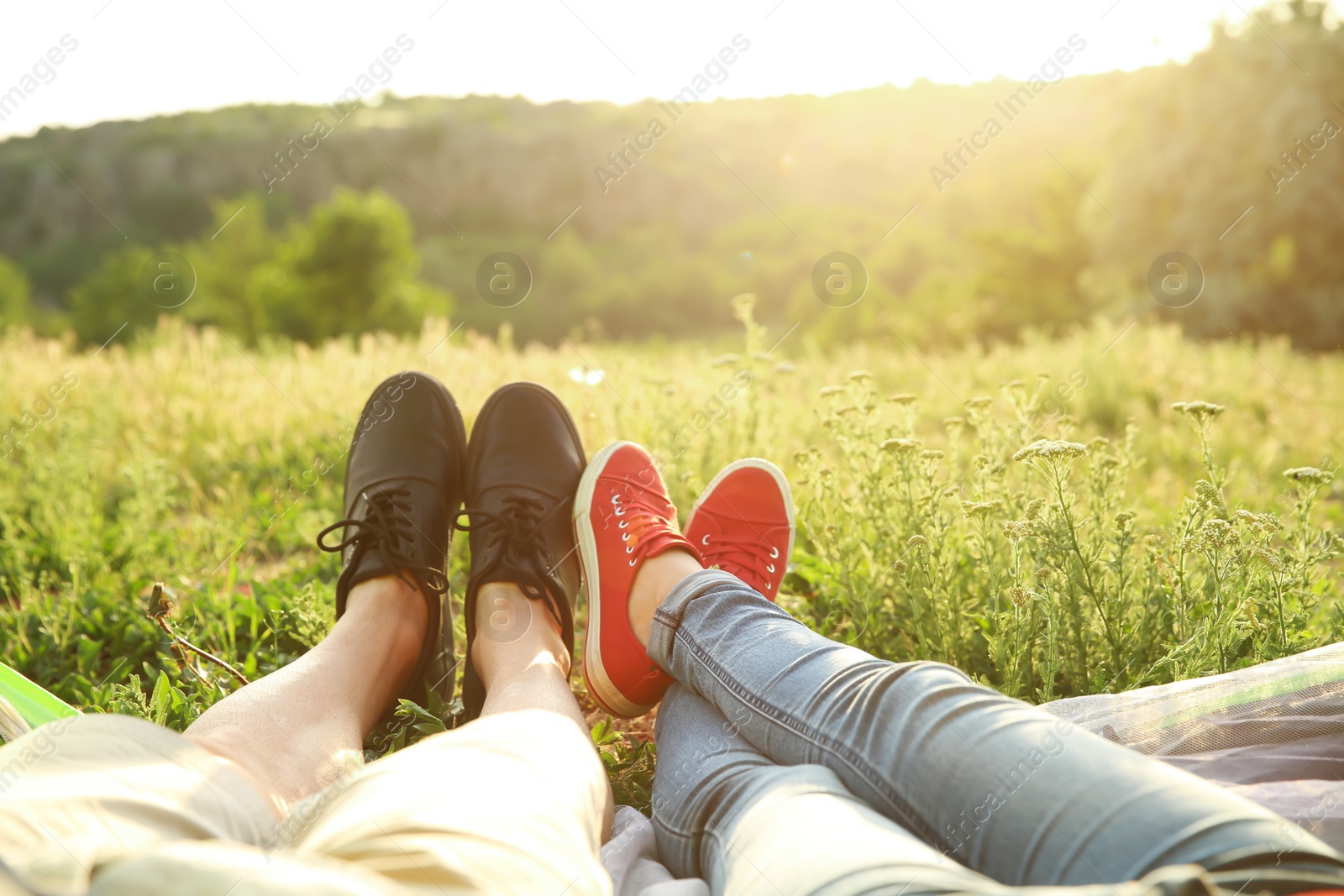 Photo of Young couple resting in wilderness. Camping season