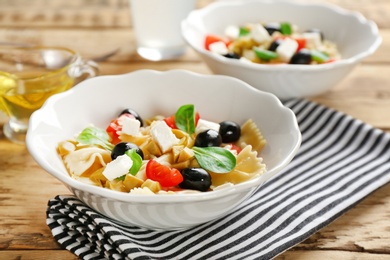 Photo of Bowls with delicious pasta primavera on table
