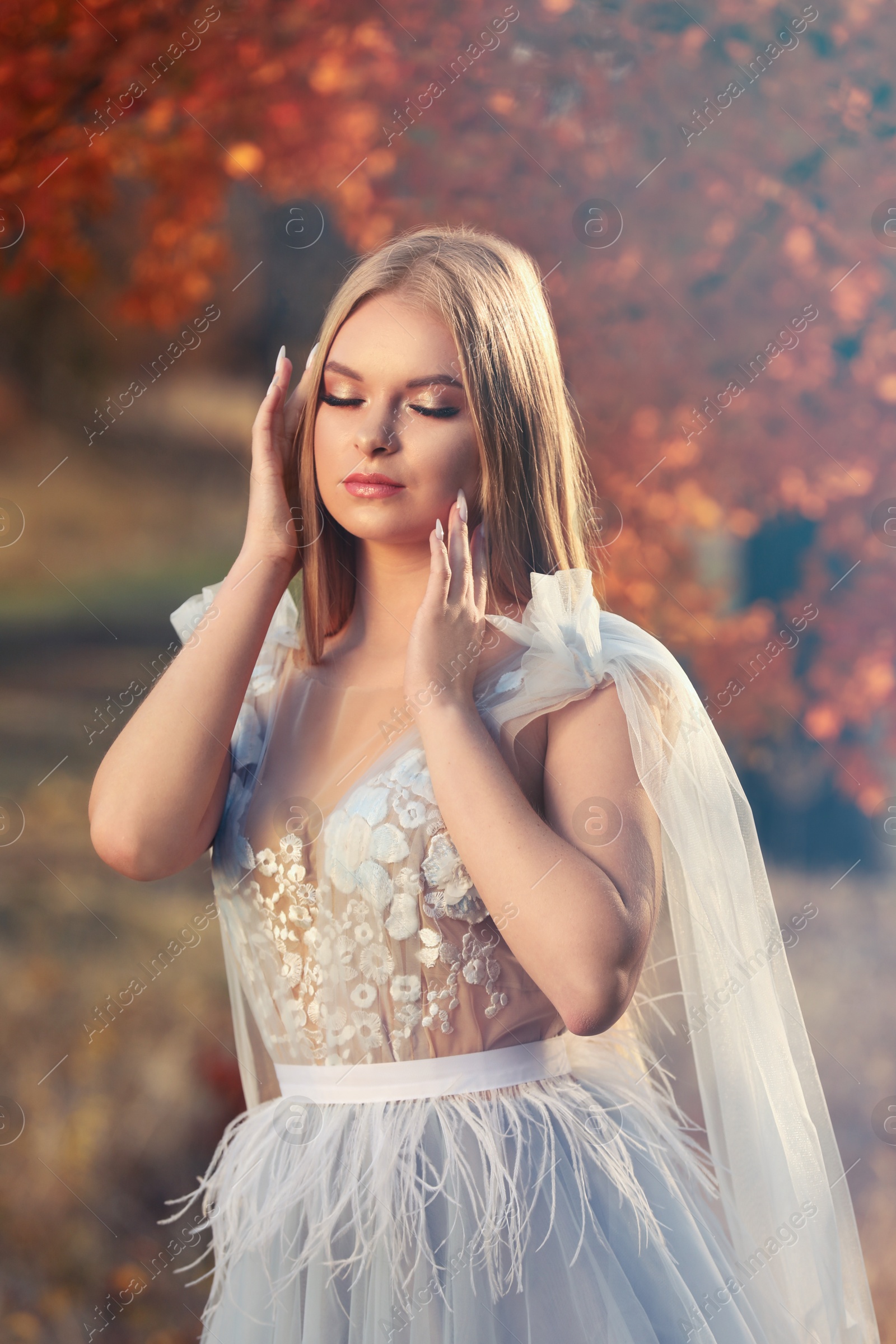 Photo of Beautiful girl wearing fairy dress in autumn forest