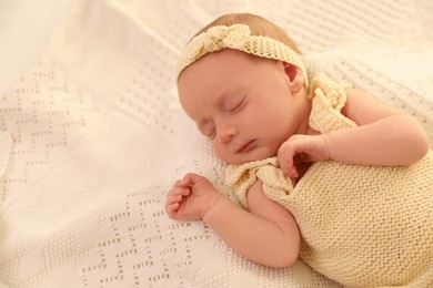 Photo of Adorable newborn baby sleeping on knitted plaid