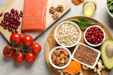 Photo of Assortment of heart-healthy products on grey background, flat lay