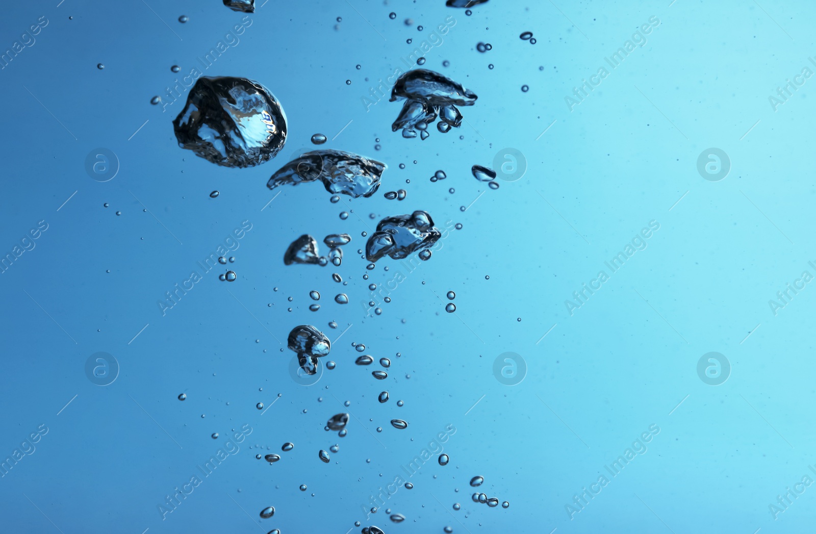 Photo of Air bubbles in water on blue background