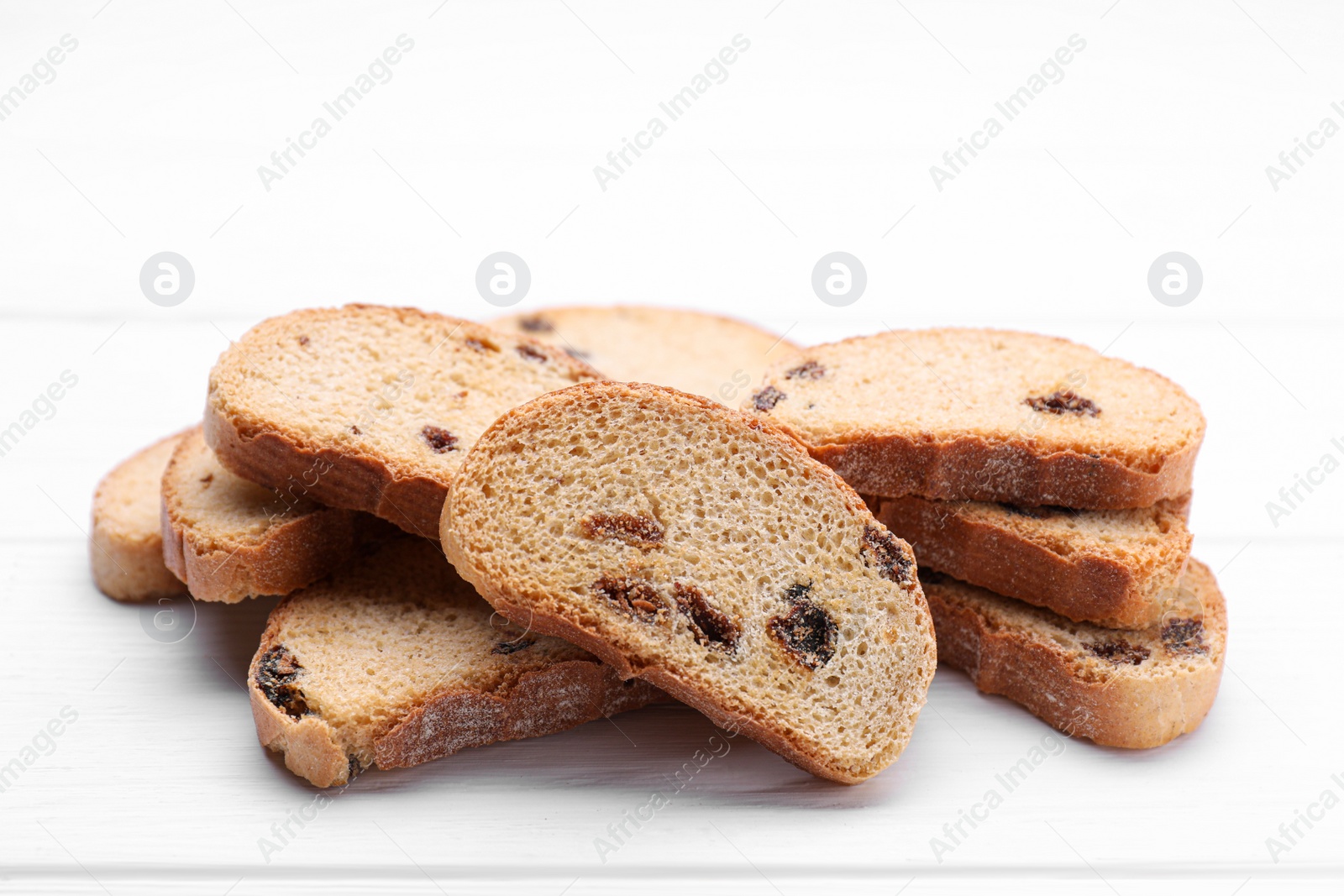 Photo of Sweet hard chuck crackers with raisins on white wooden table