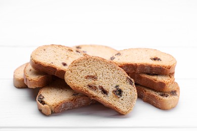 Photo of Sweet hard chuck crackers with raisins on white wooden table