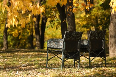 Photo of Pair of camping chairs in park on sunny day