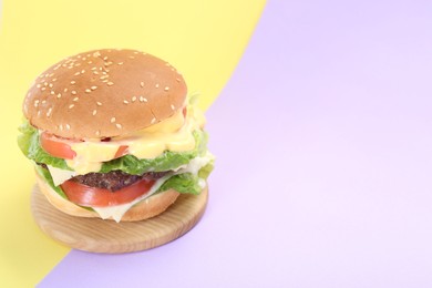 Photo of Burger with delicious patty on color background. Space for text
