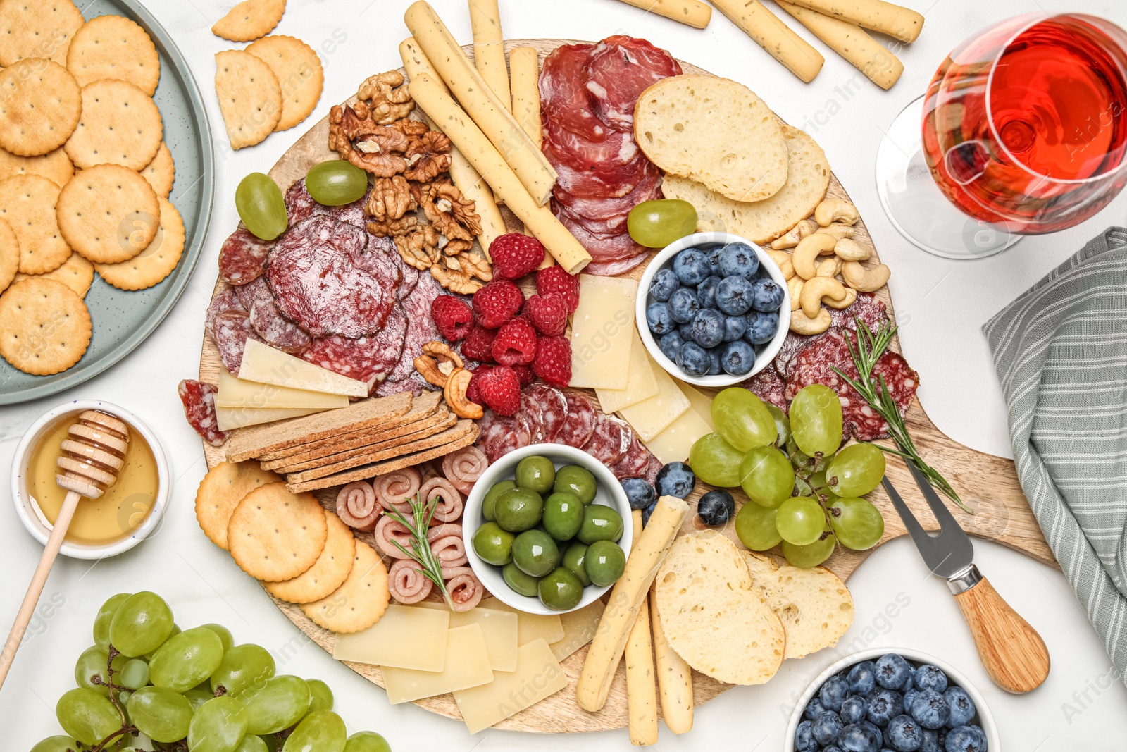 Photo of Tasty parmesan cheese and other different appetizers on white marble table, flat lay