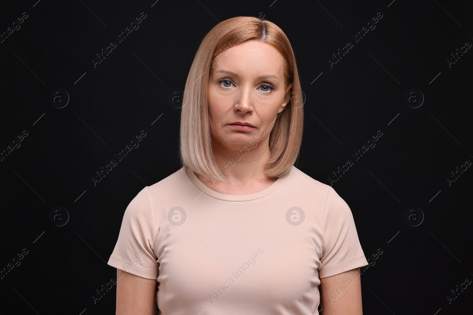 Photo of Portrait of sad woman on black background