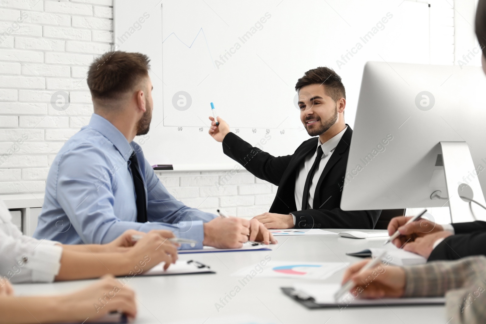 Photo of Professional business trainer working with people in office