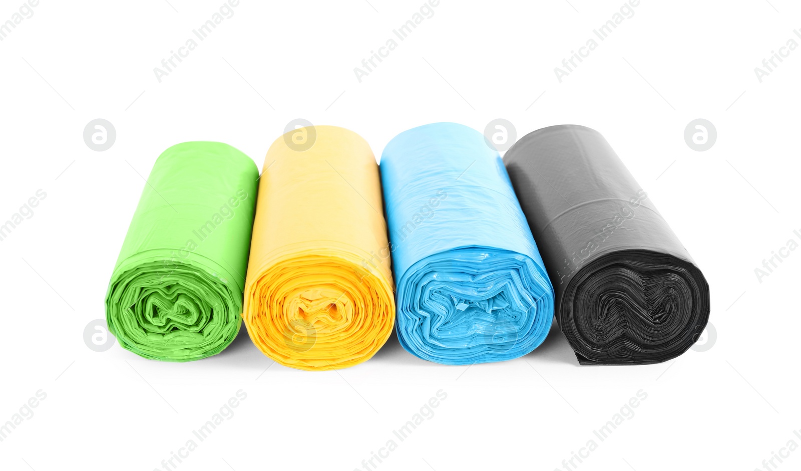 Photo of Rolls of colorful garbage bags isolated on white