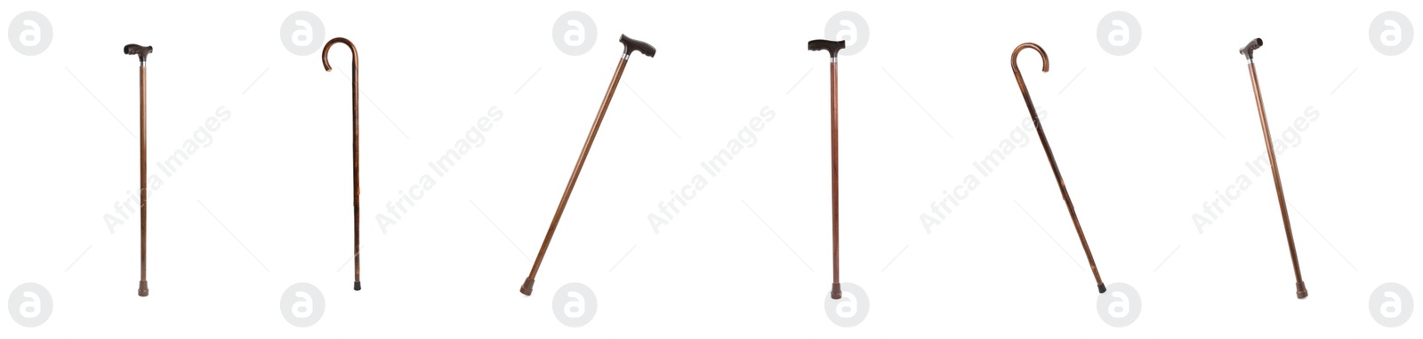 Image of Set with elegant wooden walking canes on white background. Banner design