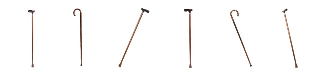 Image of Set with elegant wooden walking canes on white background. Banner design