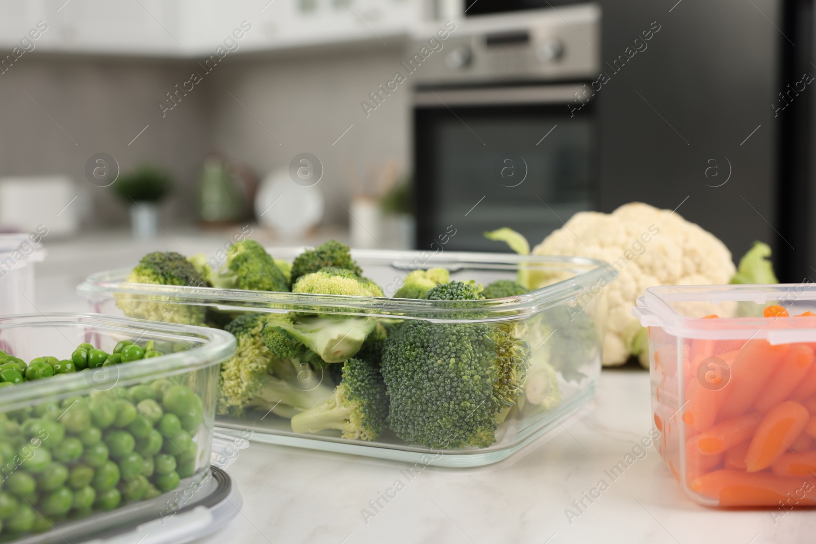 Photo of Containers with fresh products on white marble table, space for text. Food storage
