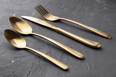 Photo of Set of beautiful cutlery on black table