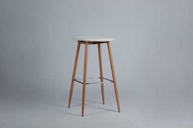 Photo of Stylish bar stool on light grey background. Interior element