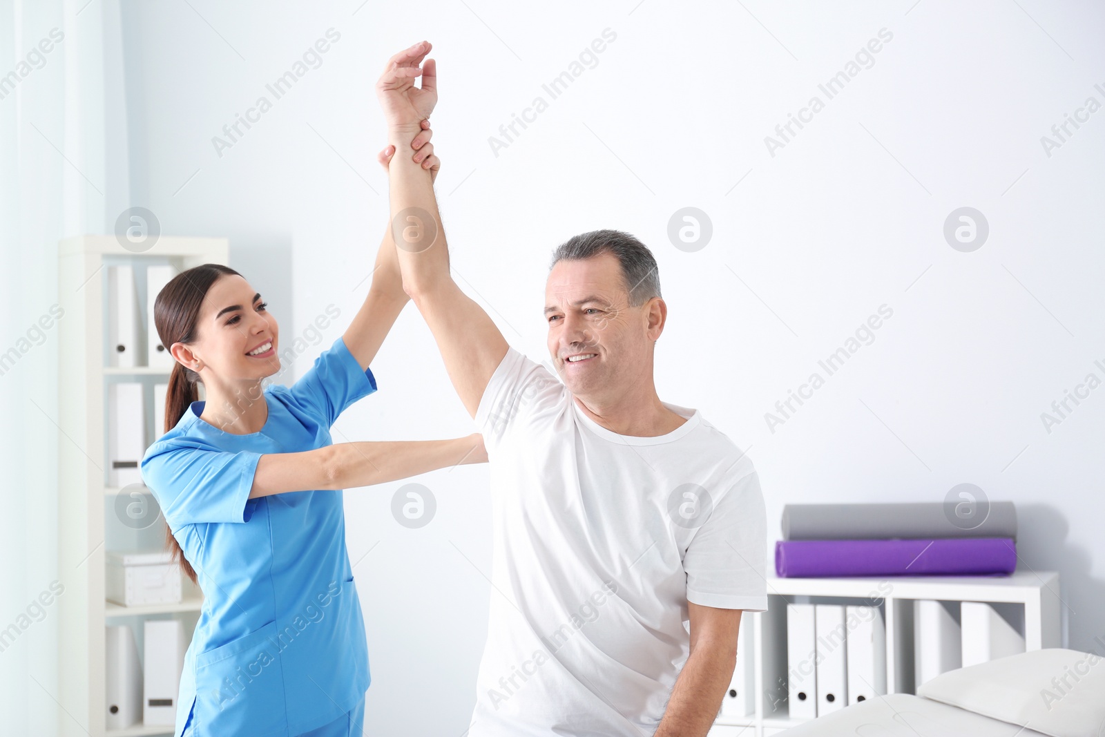 Photo of Doctor working with patient in hospital. Rehabilitation physiotherapy