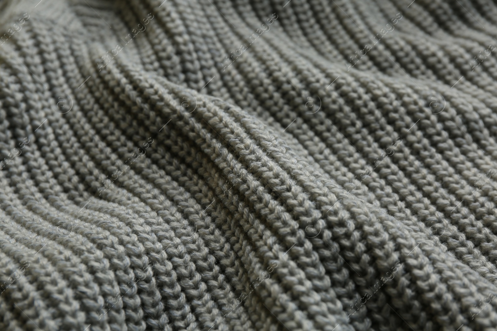 Photo of Beautiful grey knitted fabric as background, closeup