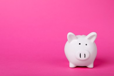 Photo of Ceramic piggy bank on pink background, space for text. Financial savings