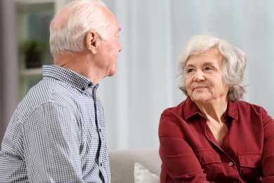 Photo of Portrait of elderly spouses on blurred background