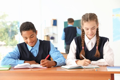 Teenage students in classroom. Stylish school uniform