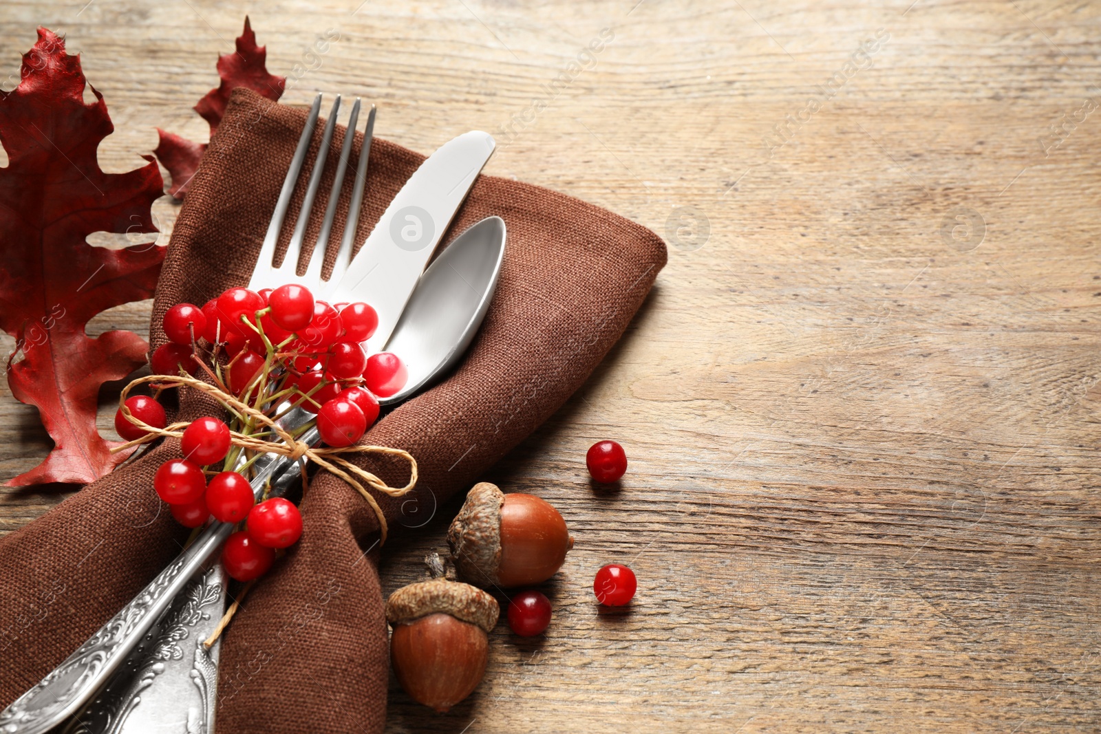 Photo of Cutlery and autumn decorations on wooden background, space for text. Happy Thanksgiving day