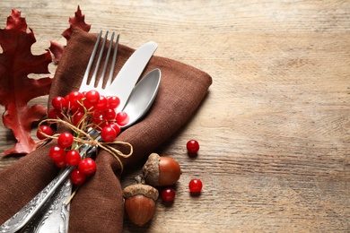 Cutlery and autumn decorations on wooden background, space for text. Happy Thanksgiving day