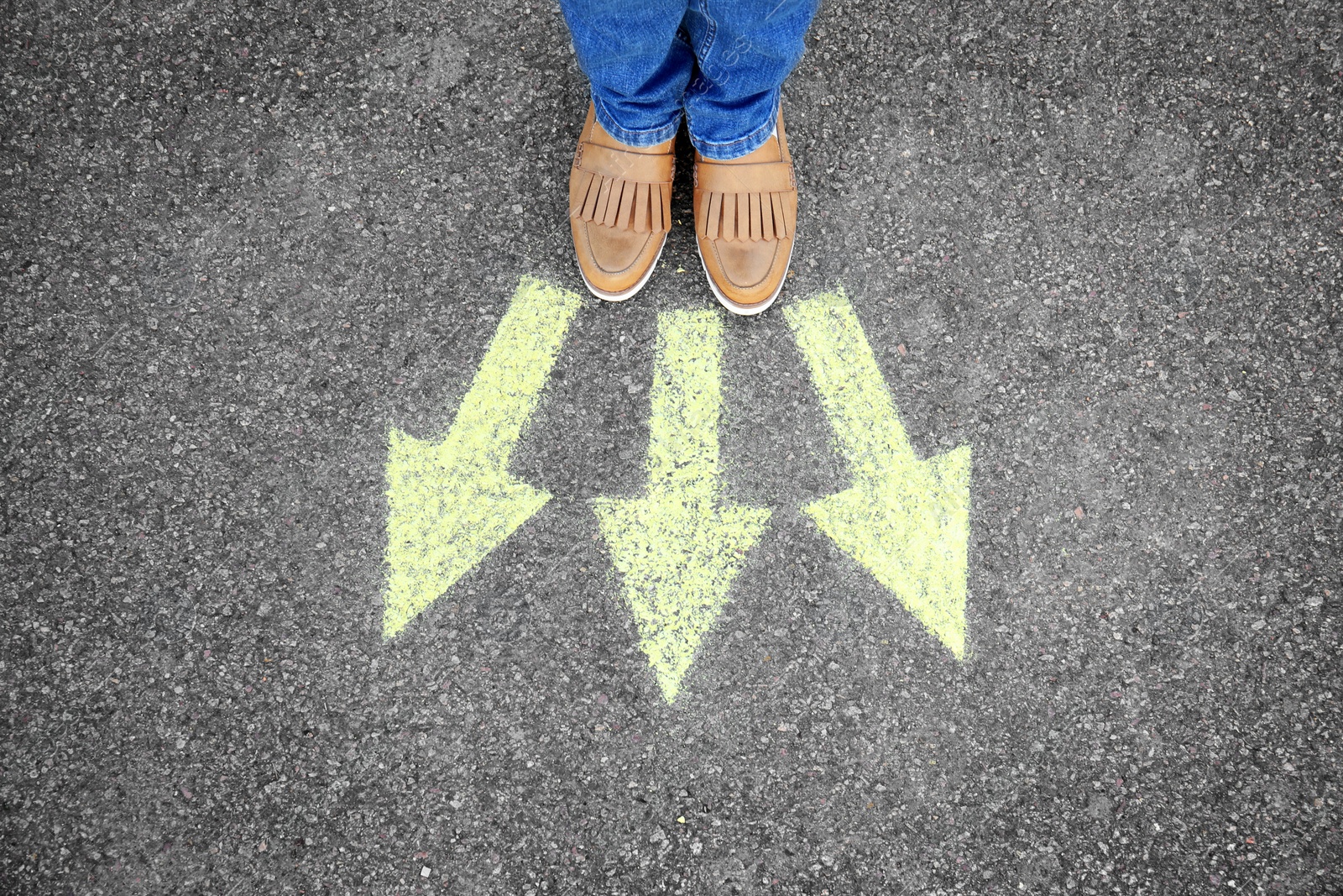 Photo of Woman standing on road near arrows marking, closeup