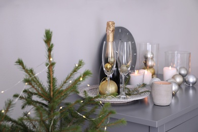 Photo of Christmas tree and decor on table indoors. Interior design