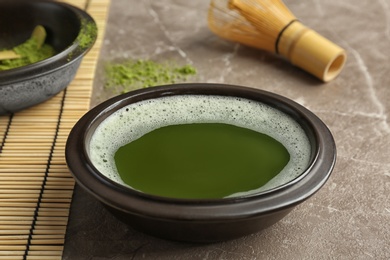 Photo of Chawan with fresh matcha tea on table