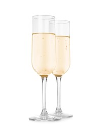 Glasses of sparkling wine on white background