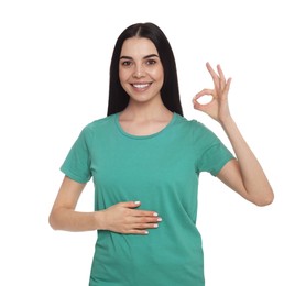 Happy healthy woman touching her belly on white background