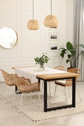 Photo of Stylish dining room with cozy furniture, mirror and plants