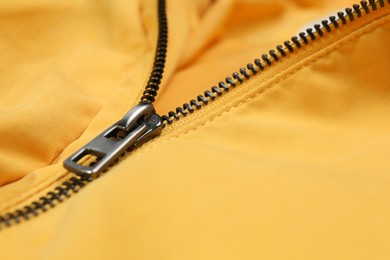 Photo of Yellow jacket with zipper as background, closeup view