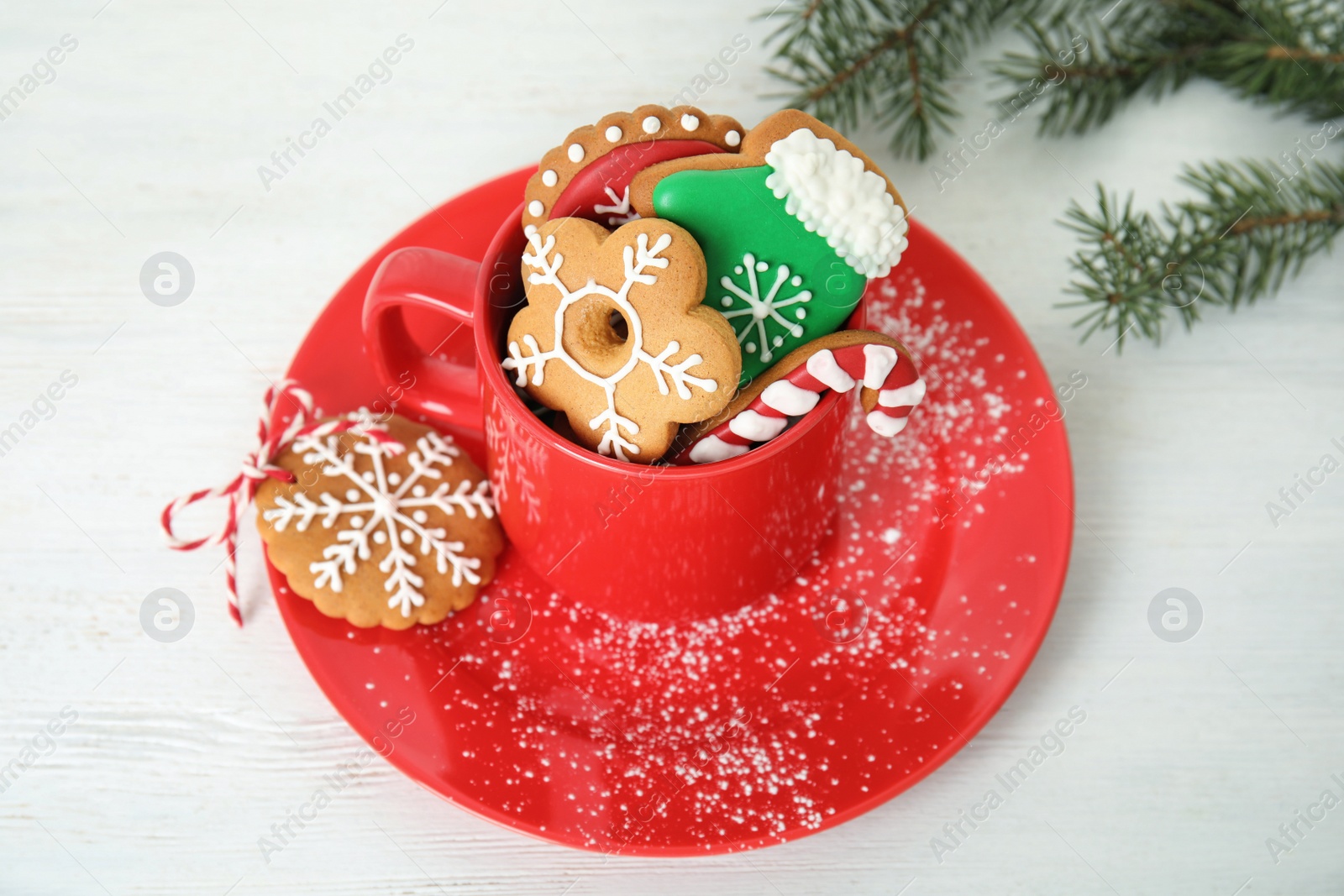 Photo of Cup with tasty homemade Christmas cookies on table