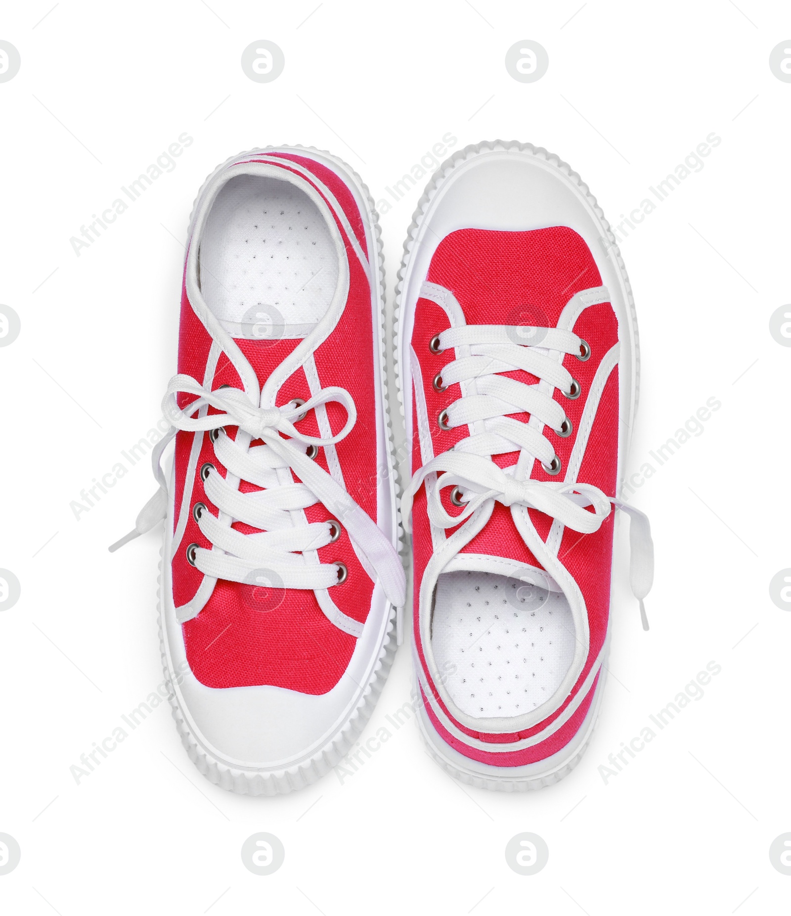 Photo of Pair of red classic old school sneakers isolated on white, top view