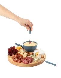 Photo of Woman dipping grape into fondue pot with melted cheese on white background, closeup