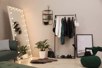 Modern dressing room interior with clothing rack and mirror