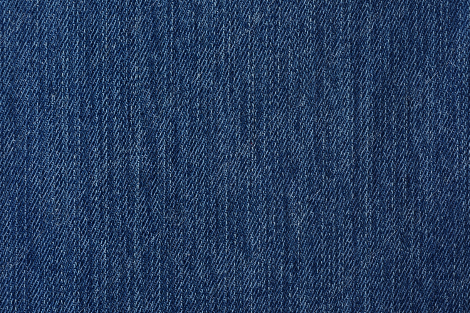 Photo of Texture of blue jeans as background, closeup