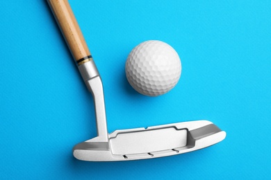 Photo of Golf ball and club on color background, flat lay. Sport equipment