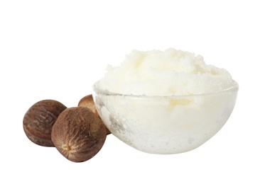 Shea butter in bowl and nuts isolated on white