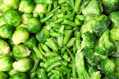 Photo of Mix of frozen vegetables as background, top view