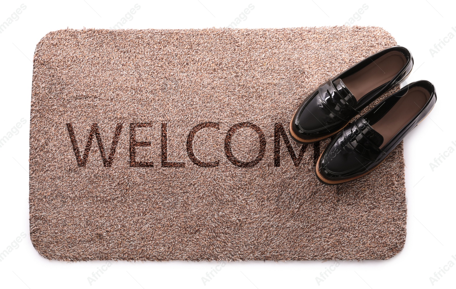 Image of Door mat with word WELCOME and shoes on white background, top view