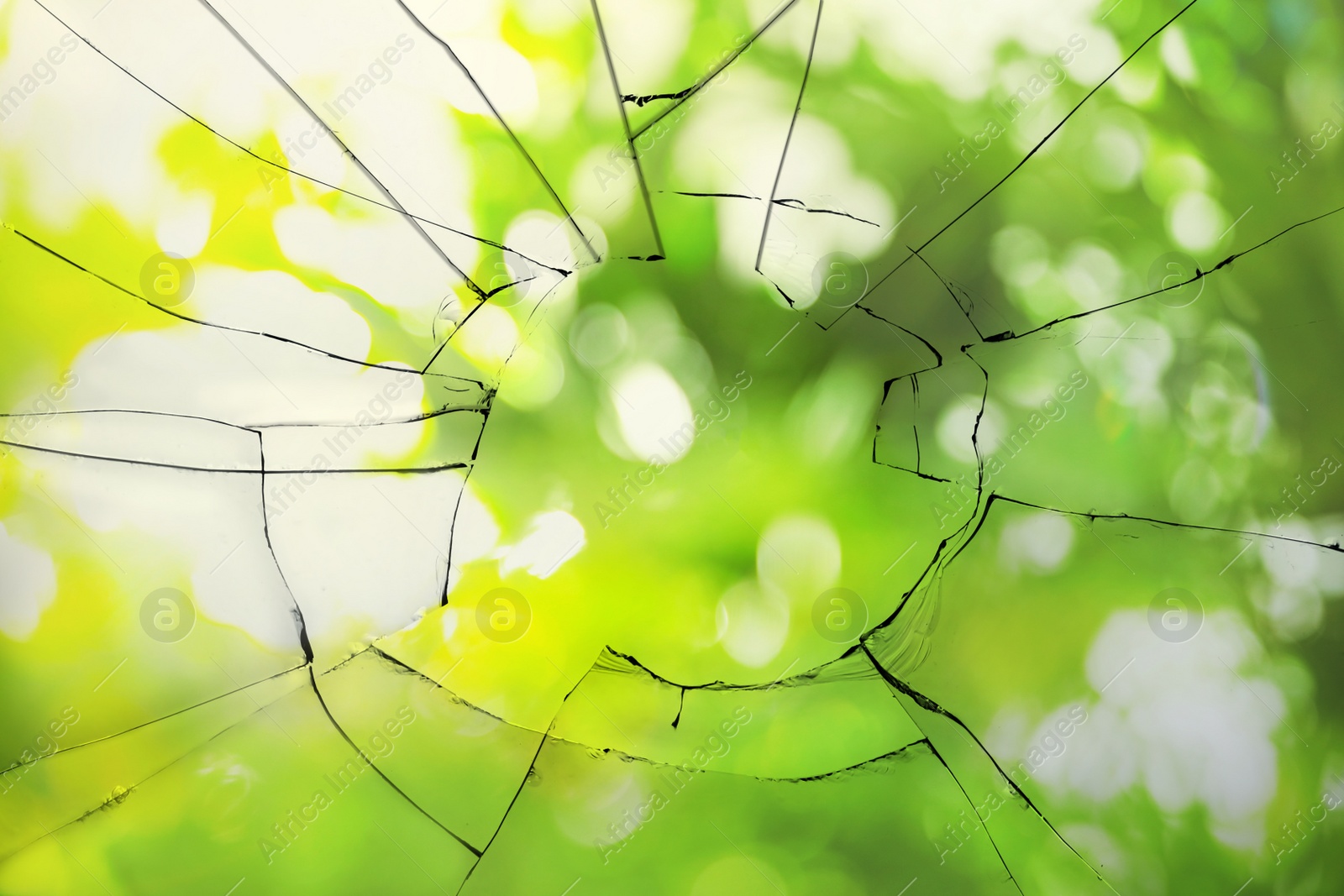 Image of View through broken window on blurred green background